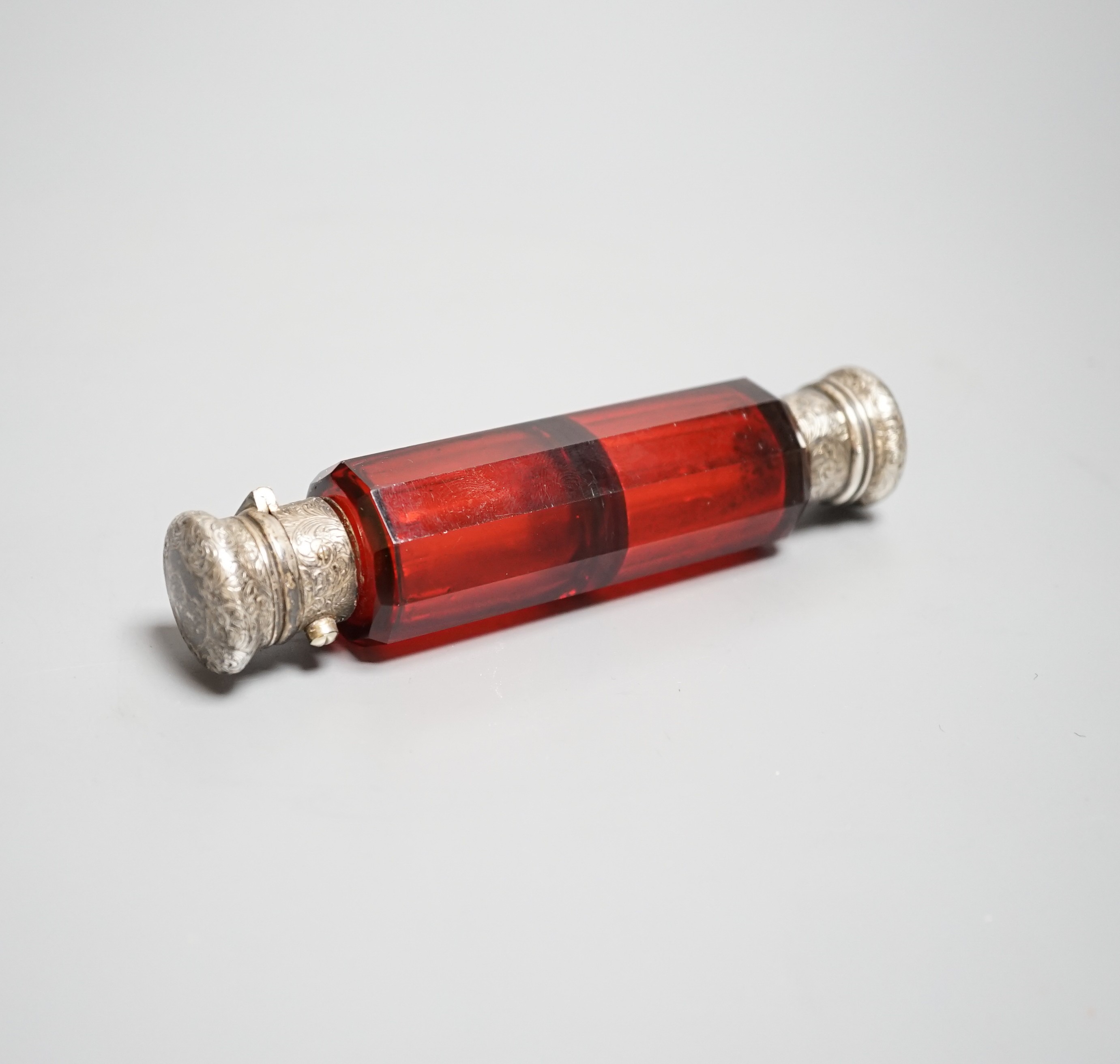 A Victorian engraved white metal and ruby glass double ended scent bottle, 12.7cm.